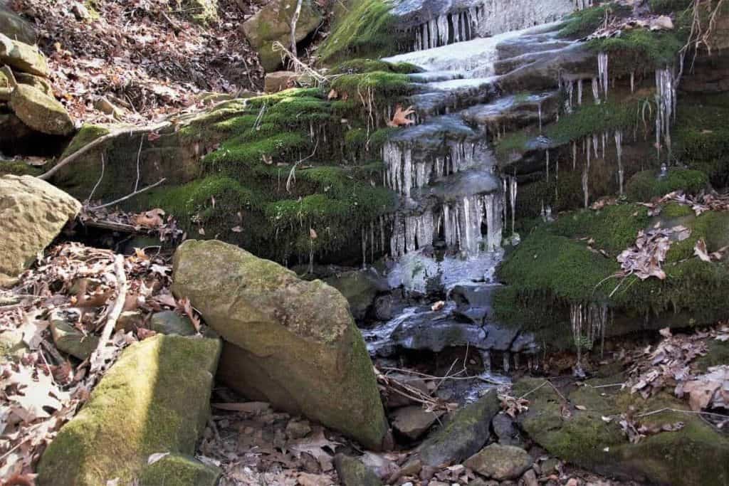 Frozen waterfalls over green moss covered rocks winter hiking, southern Illinois & stone forts